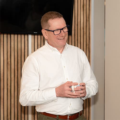 Dyfrig Jenkins holding a coffee during an in-person session.